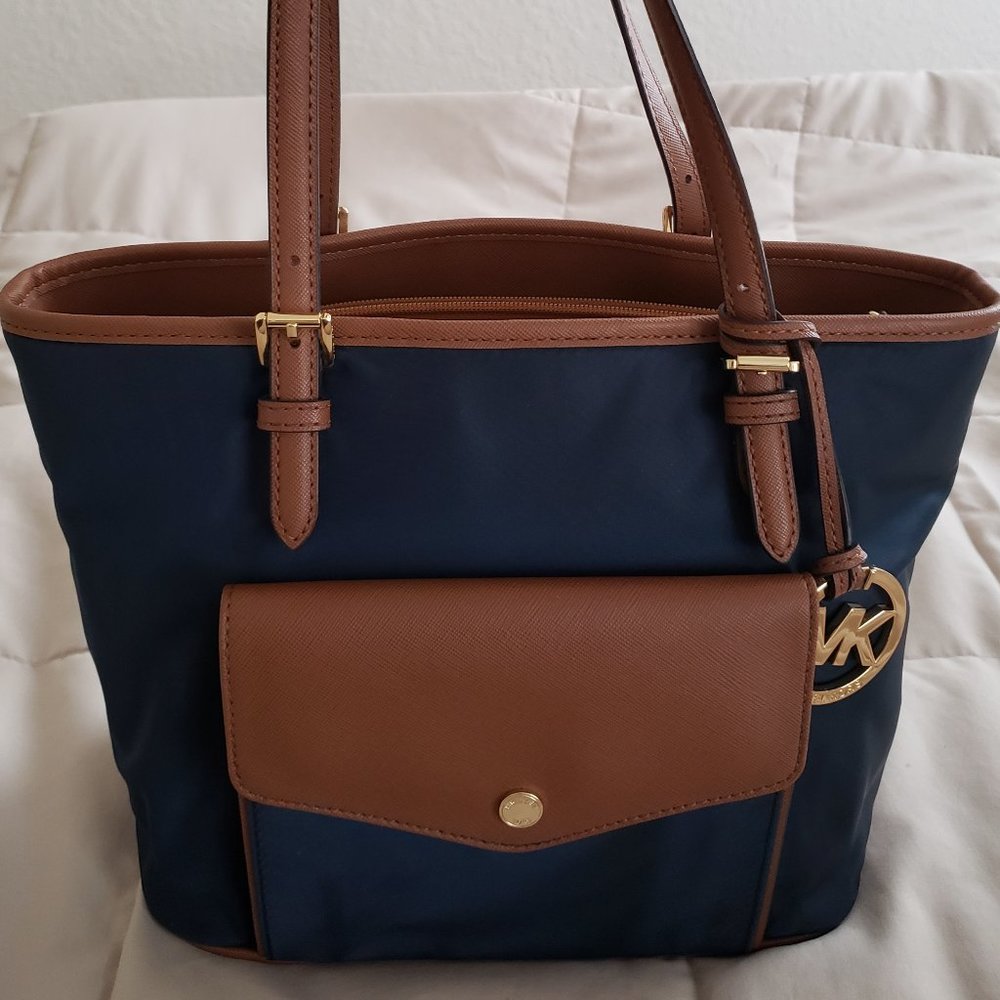 SOLD. Michael Kors Nylon navy and brown with front snap pocket purse. Great cond